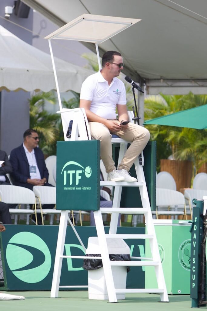 Tennis referee overseeing a match at the ITF Davis Cup in Luanda, Angola.